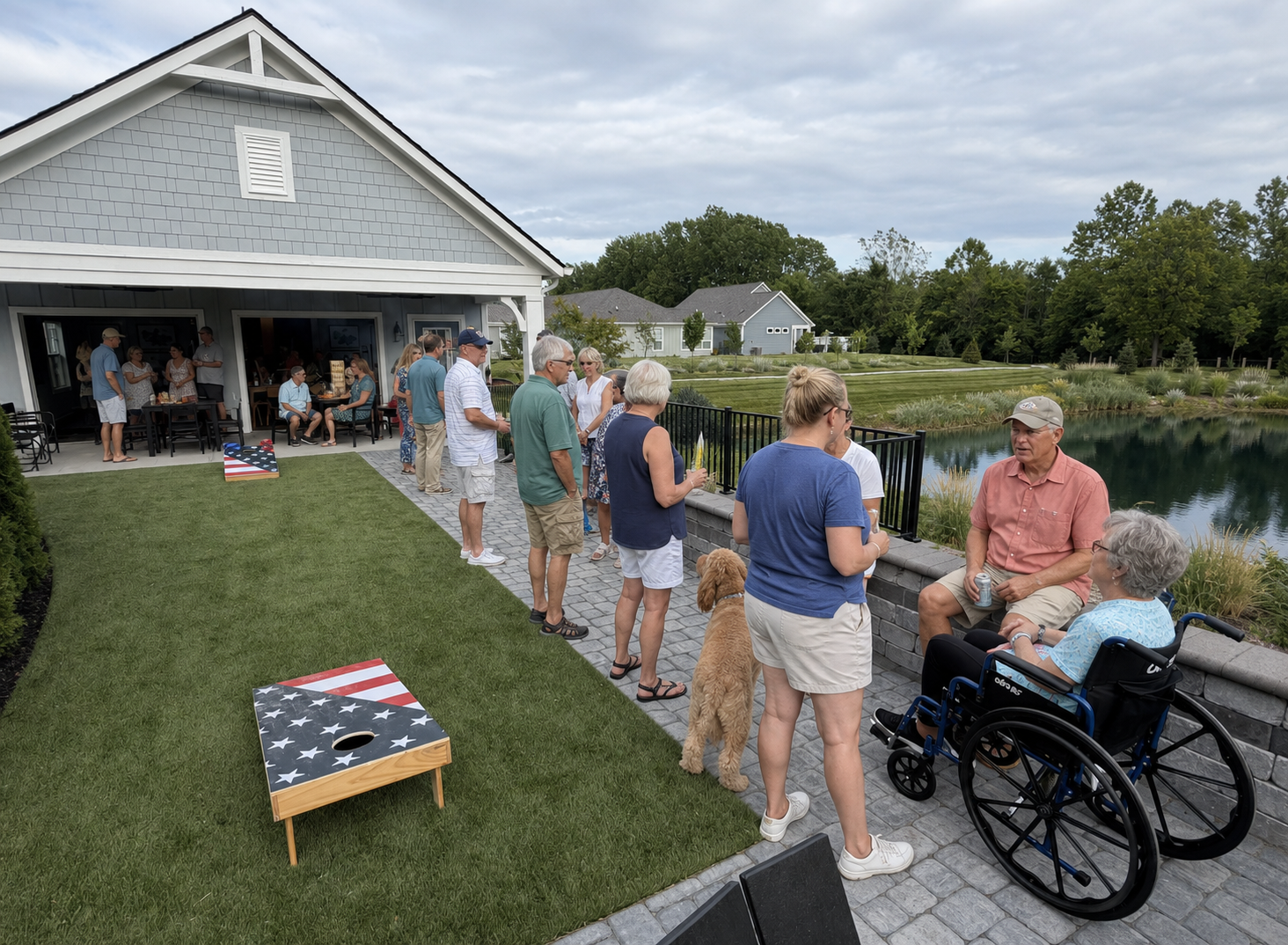 Neighbors gathered for a cornhole get-together by the pond and community shelter